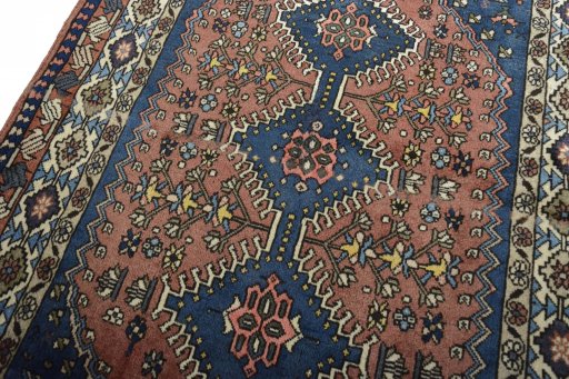 Backside of handmade 2000s Yalameh rug showing knot structure and weave density