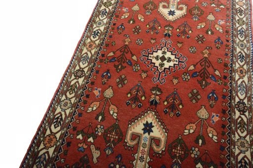 Backside of handmade 2000s Yalameh rug showing knot structure and weave density