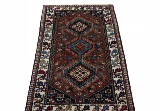Surface texture of 2000s Yalameh rug with natural Wool and intricate pattern