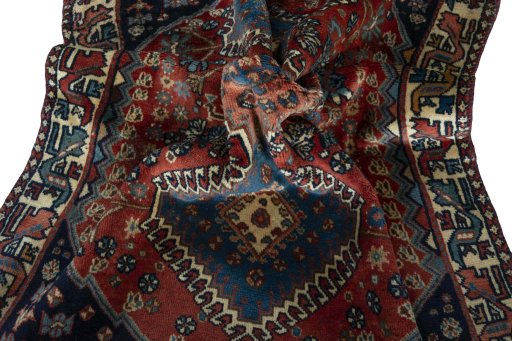 Corner detail of 1970s Yalameh rug showing border pattern and Wool pile