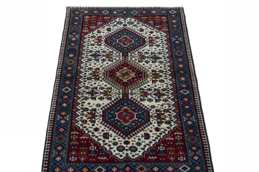 Surface texture of 2000s Yalameh rug with natural Wool and intricate pattern