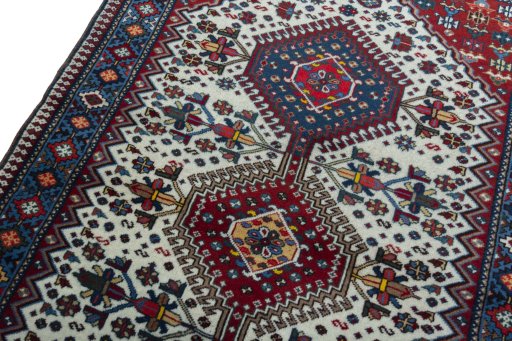 Backside of handmade 2000s Yalameh rug showing knot structure and weave density