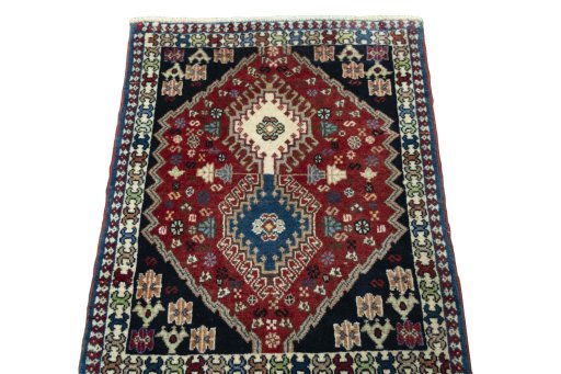 Surface texture of 2000s Yalameh rug with natural Wool and intricate pattern