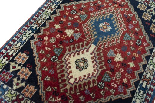 Backside of handmade 2000s Yalameh rug showing knot structure and weave density