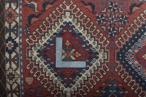 Surface texture of 2000s Yalameh rug with natural Wool and intricate pattern