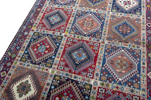 Backside of handmade 2000s Yalameh rug showing knot structure and weave density