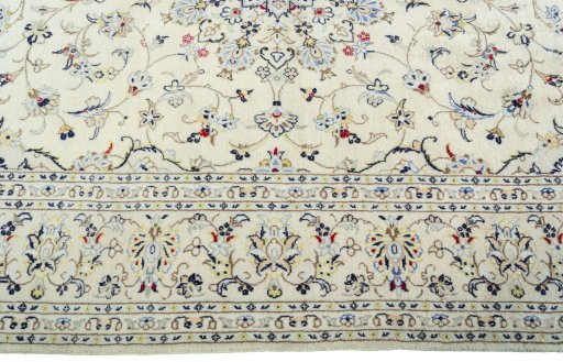 Corner detail of 2000s Kashan rug showing border pattern and Wool pile