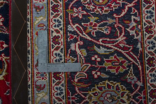 Backside of handmade 2000s Kashan rug showing knot structure and weave density