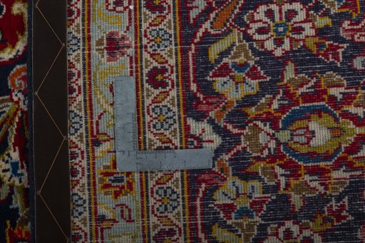 Backside of handmade 2000s Kashan rug showing knot structure and weave density