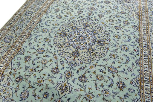 Backside of handmade 2000s Kashan rug showing knot structure and weave density