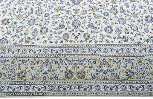 Corner detail of 2000s Kashan rug showing border pattern and Wool pile