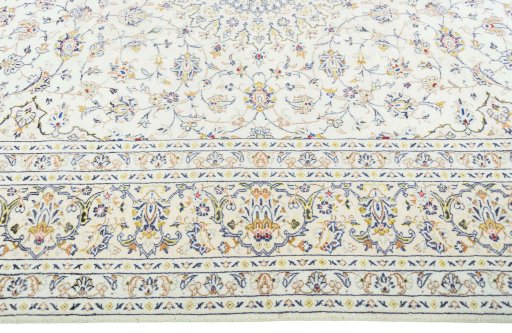Corner detail of 2000s Kashan rug showing border pattern and Wool pile