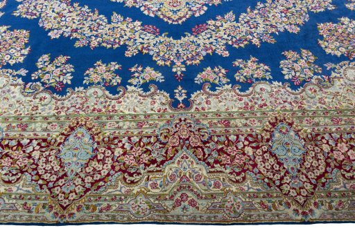 Corner detail of 1970s Kerman rug showing border pattern and Wool pile