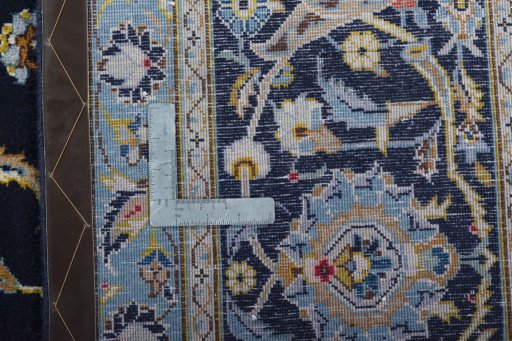 Backside of handmade 2000s Kashan rug showing knot structure and weave density