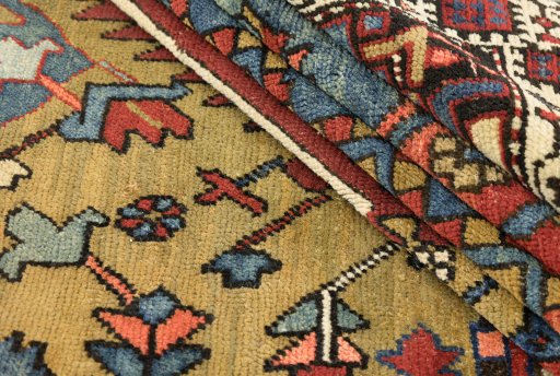 Close-up detail of 1900s Vintage rug from Iran / Persia showing Wool weave