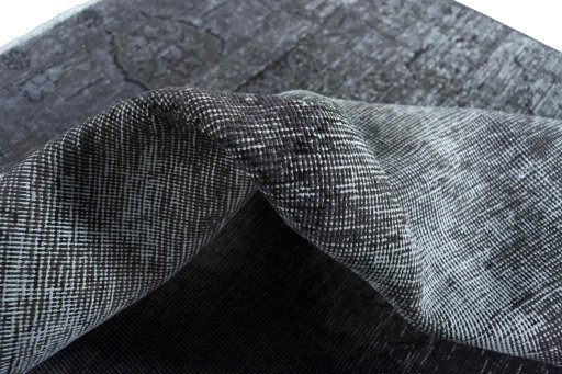 Surface texture of 1970s Vintage rug with natural Wool and intricate pattern