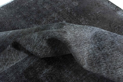 Surface texture of 1970s Vintage rug with natural Wool and intricate pattern