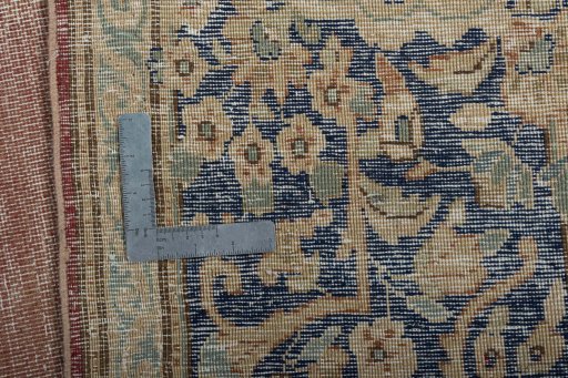 Backside of handmade 1950s Vintage rug showing knot structure and weave density