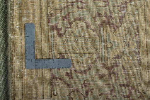 Backside of handmade 1950s Vintage rug showing knot structure and weave density