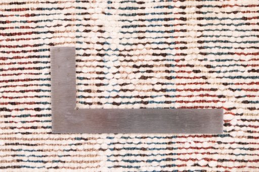 Corner detail of 1940s Vintage rug showing border pattern and Wool pile