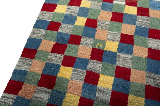 Backside of handmade 2000s Persian Gabbeh rug showing knot structure and weave density