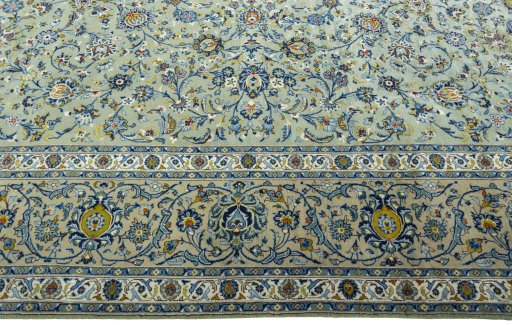 Corner detail of 2000s Kashan rug showing border pattern and Wool pile