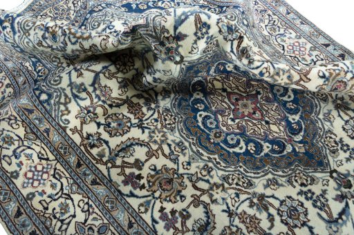 Surface texture of 2000s Nain rug with natural Wool and intricate pattern