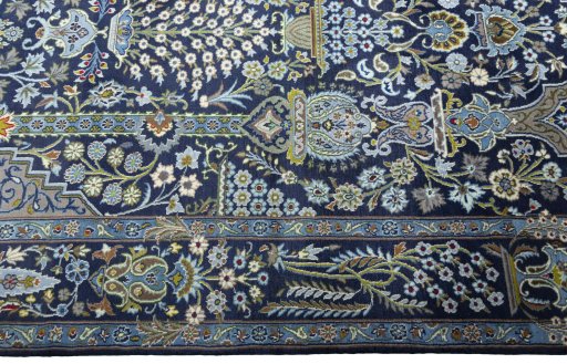 Corner detail of 2000s Kashan rug showing border pattern and Wool pile