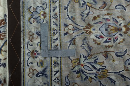Backside of handmade 2000s Kashan rug showing knot structure and weave density