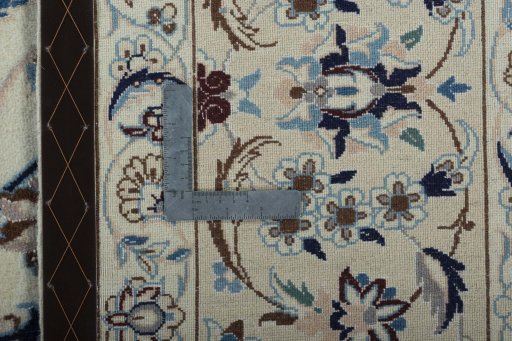 Backside of handmade 2000s Nain rug showing knot structure and weave density
