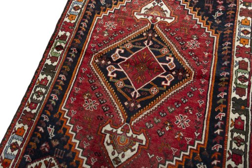 Backside of handmade 2000s Shiraz rug showing knot structure and weave density