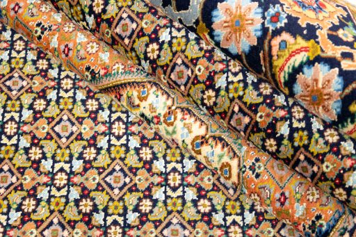 Corner detail of 1990s Tabriz Silk rug showing border pattern and Wool pile