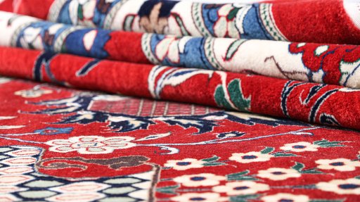 Corner detail of New Tabriz Silk rug showing border pattern and Silk pile