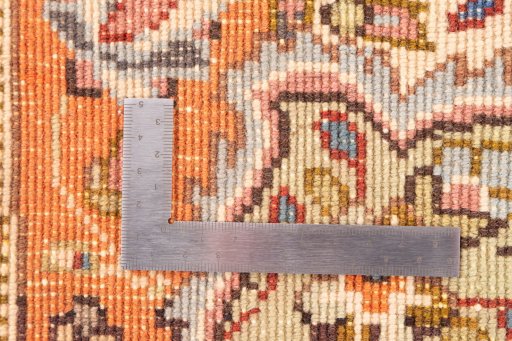 Corner detail of 1998s Tabriz Silk rug showing border pattern and Wool pile