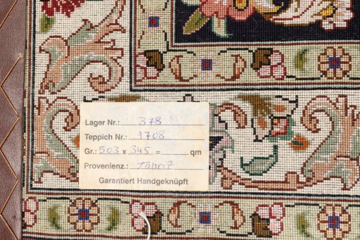 Corner detail of 2020s Tabriz Silk rug showing border pattern and Wool pile