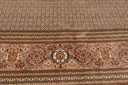 Corner detail of 2018s Tabriz Silk rug showing border pattern and Wool pile