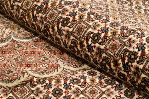 Backside of handmade New Tabriz Silk rug showing knot structure and weave density