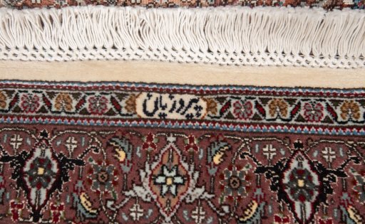 Corner detail of New Tabriz Silk rug showing border pattern and Wool pile