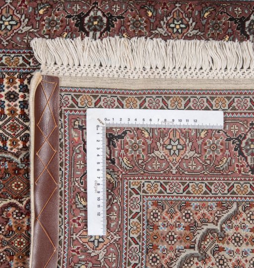 Backside of handmade New Tabriz Silk rug showing knot structure and weave density