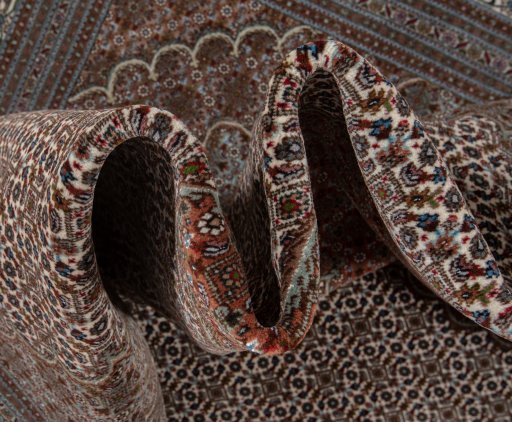 Backside of handmade New Tabriz Silk rug showing knot structure and weave density