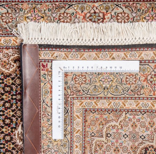 Close-up detail of New Tabriz Silk rug from Iran / Persia showing Wool weave