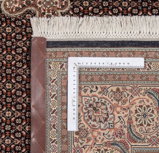 Backside of handmade New Tabriz Silk rug showing knot structure and weave density