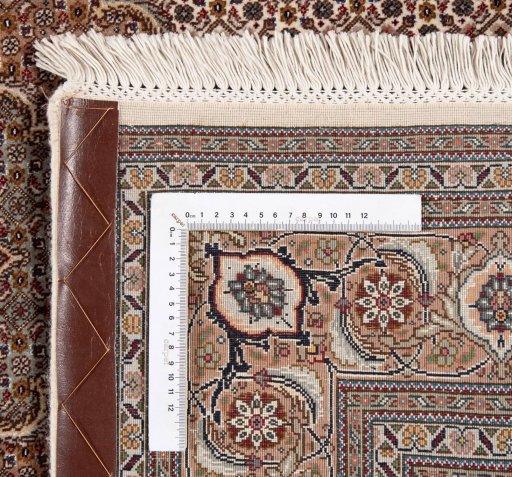 Backside of handmade New Tabriz Silk rug showing knot structure and weave density