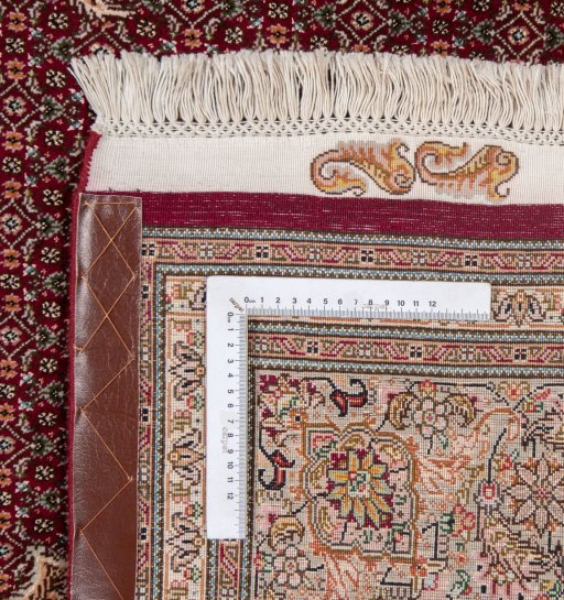 Backside of handmade New Tabriz Silk rug showing knot structure and weave density