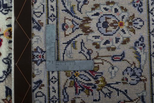 Backside of handmade 2000s Kashan rug showing knot structure and weave density