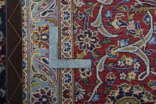 Backside of handmade New Kashan rug showing knot structure and weave density