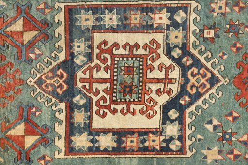 Corner detail of 1900s Kazak rug showing border pattern and Wool pile