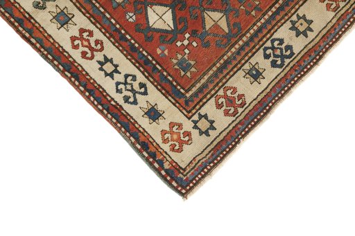 Backside of handmade 1900s Kazak rug showing knot structure and weave density