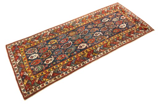 Corner detail of 1900s Kazak rug showing border pattern and Wool pile