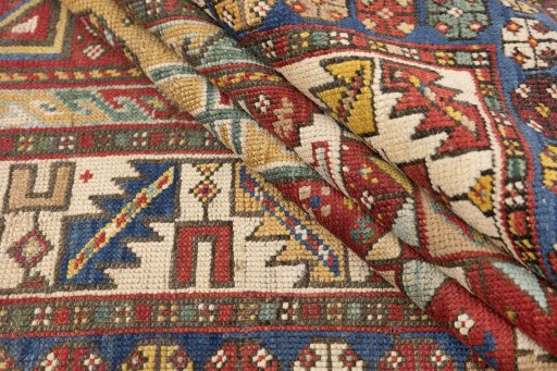 Corner detail of 1900s Kazak rug showing border pattern and Wool pile